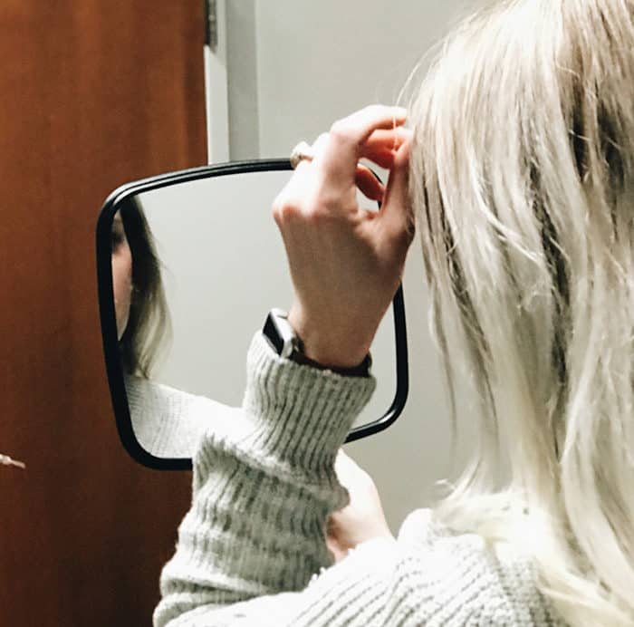 client holding mirror