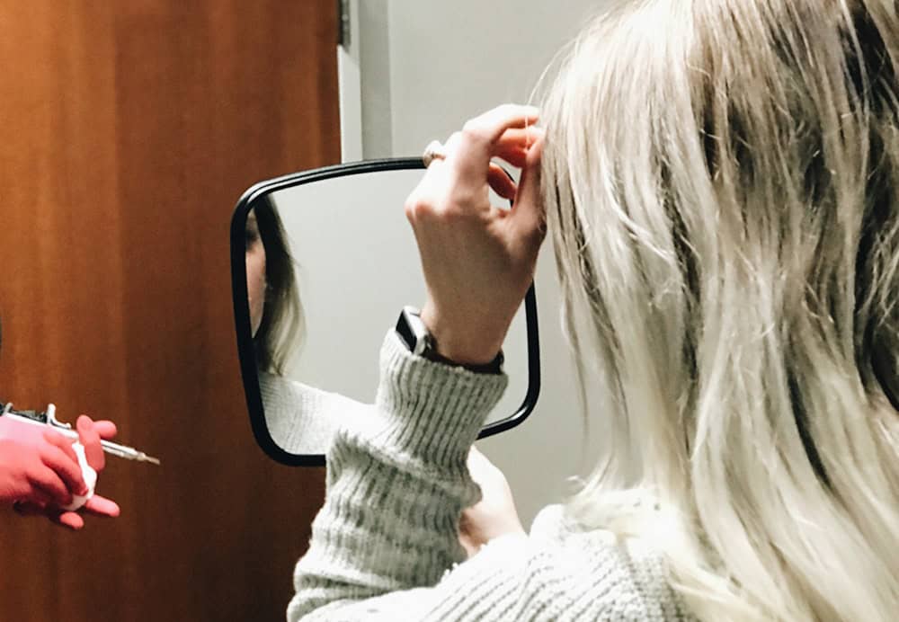 client holding mirror