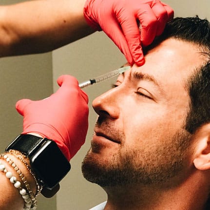 botox on male model's forehead