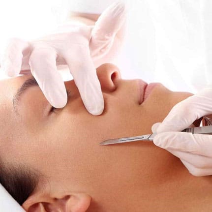 dermaplaning client's face