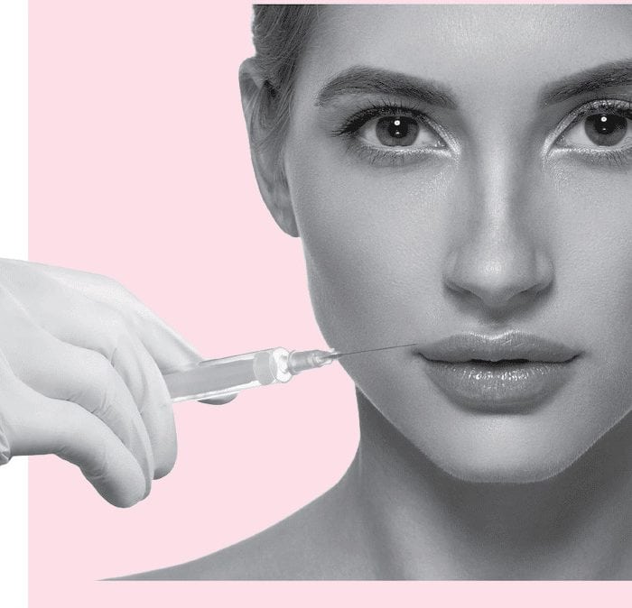 model holding filler syringe to lips