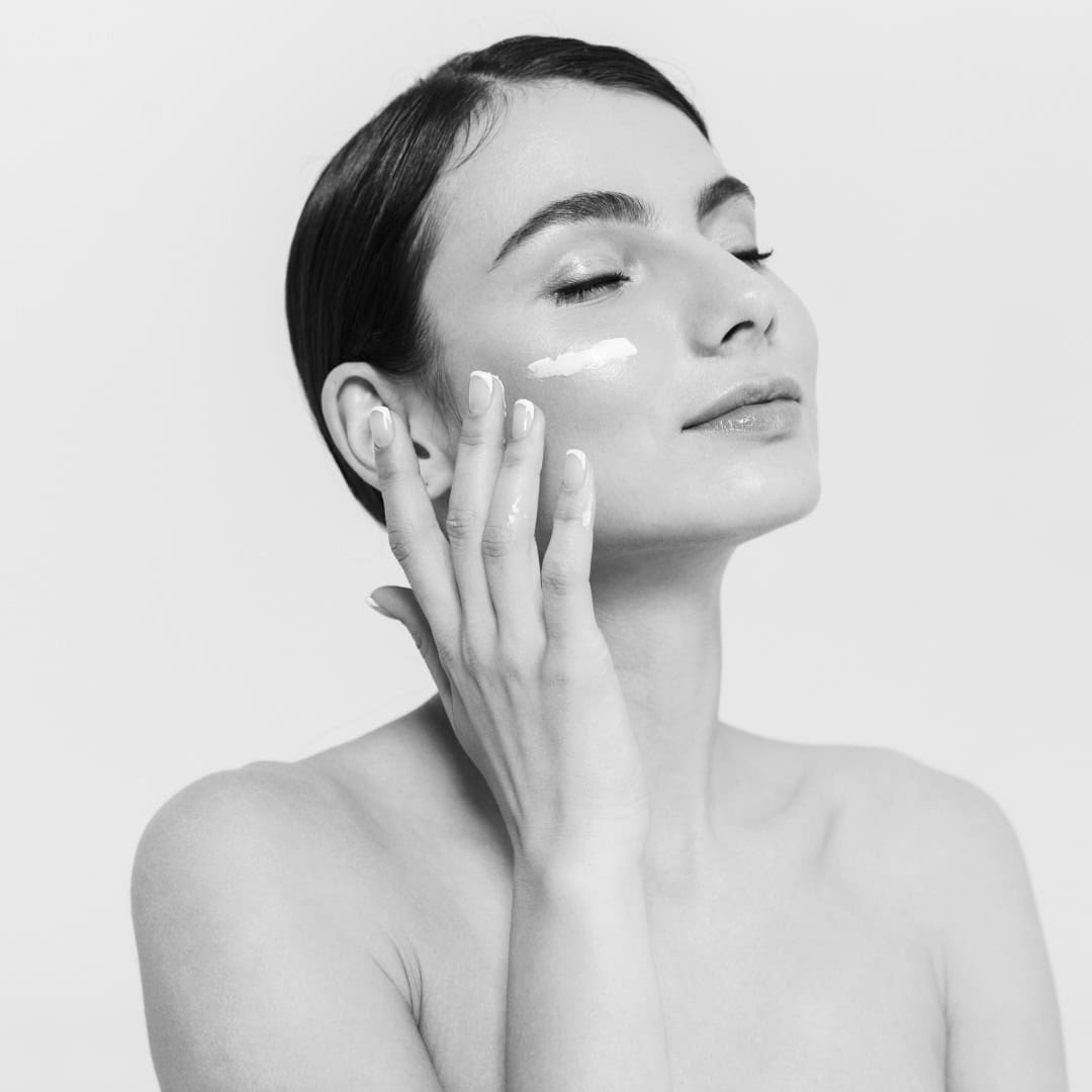 model with skincare on cheek