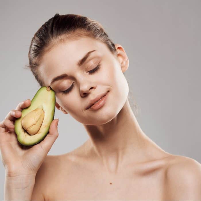 model holding avocado