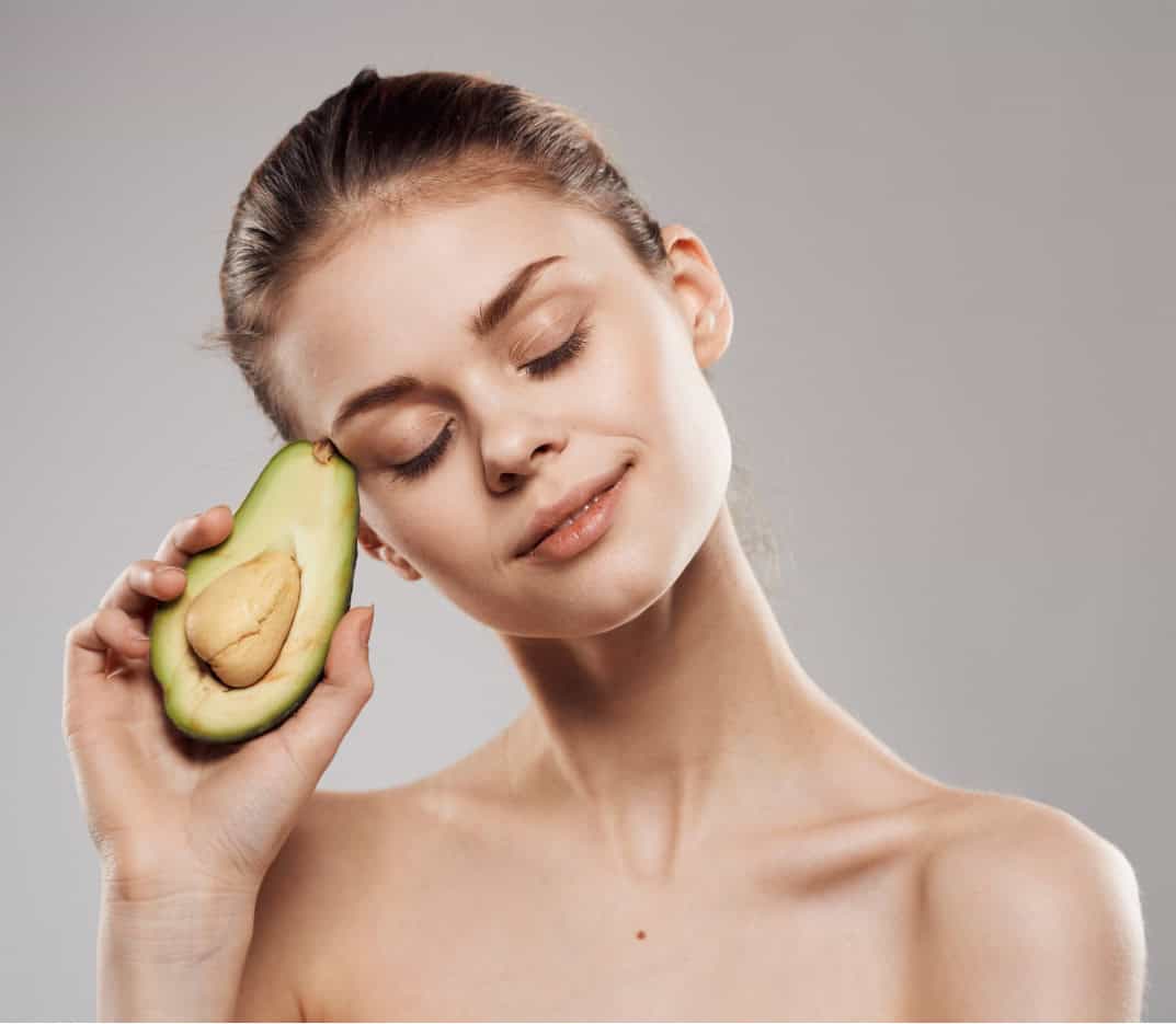 model holding avocado