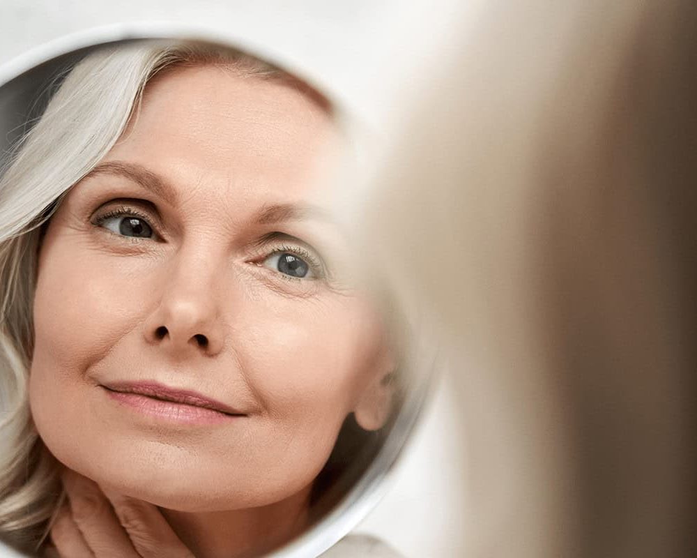 woman looking in mirror